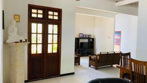 a room with a door with a statue of a woman at MAYU Homestay in Dickwella