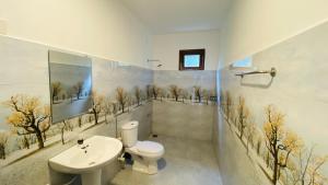 a bathroom with a toilet and a sink at MAYU Homestay in Dickwella +19 photos