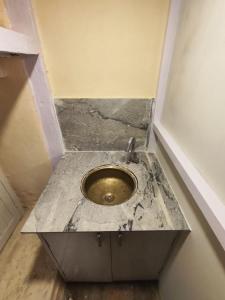 a bathroom with a sink in the floor of a room at Sanjhyā Durbar Homestay in Bhaktapur +9 photos