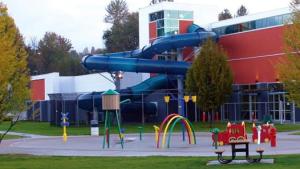 a playground with a slide in front of a building at Guest Suite in Mission in Mission