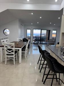 a kitchen and dining room with a table and chairs at Sapphire By The Sea in Diamond Beach
