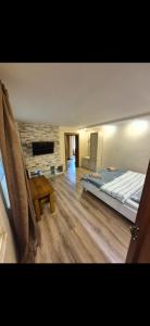 a bedroom with a large bed and a wooden floor at Над Річкою in Yaremche +11 photos