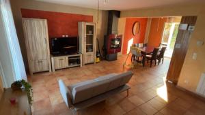 a living room with a couch and a table at Maison Grebert in Gouffern en Auge