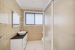 a bathroom with a toilet sink and a shower at Sapphire By The Sea in Diamond Beach