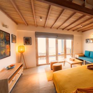 a bedroom with a bed and a living room at Kitesurfing Lanka in Kalpitiya