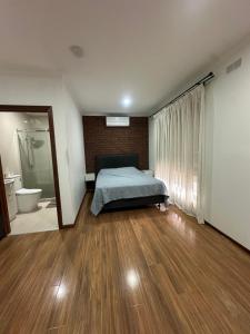 a bedroom with a bed and a bathroom at Guest Room in Kealba in St Albans +32 photos