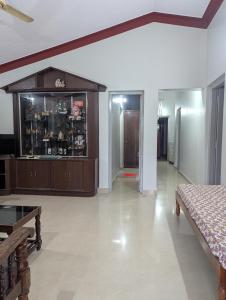 a living room with a dresser in the middle of a room at Coorg homes in Madikeri