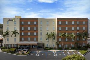 a hotel with palm trees in a parking lot at Home2 Suites by Hilton Florida City in Florida City
