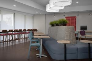 a waiting room with chairs and tables and a couch at Home2 Suites by Hilton Florida City in Florida City +34 photos