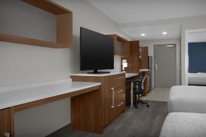 a hotel room with a flat screen tv on a counter at Home2 Suites by Hilton Florida City in Florida City