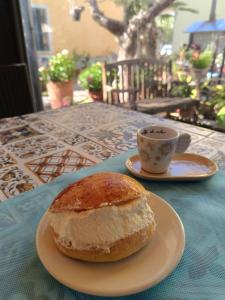 a pastry on a plate next to a cup of coffee at Residenza Cieloterra in Rivotorto