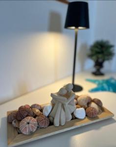 a table with a tray with rocks and a lamp at Myrto Signature Suite - Aegina in Aegenitissa +23 photos