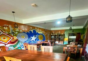 a dining room with a table and a colorful wall at Queens Ark in Nallathanniya +33 photos