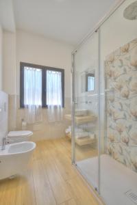 a bathroom with a shower and a toilet and a sink at Guest House al porto in Civitavecchia +22 photos
