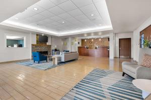 a large living room with couches and a fireplace at Comfort Inn & Suites Marion I-57 in Marion