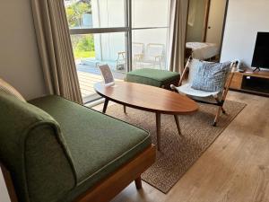 a living room with a couch and a table at Recasa in Imabari