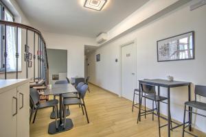a room with tables and chairs and a hallway at Guest House al porto in Civitavecchia