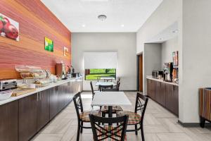 a restaurant with a table and chairs in a room at Quality Inn Rochester South in Rochester