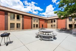 a courtyard with tables and benches in front of a building at Quality Inn Rochester South in Rochester