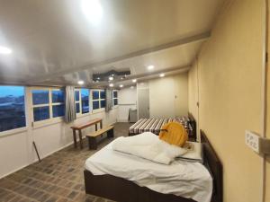 a hospital room with two beds and a table at Sanjhyā Durbar Homestay in Bhaktapur