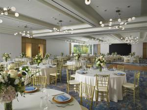 a banquet hall with white tables and chairs and flowers at Hilton Arcadia Los Angeles in Arcadia +71 photos