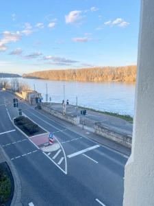an empty road next to a body of water at Hostel am Rhein - Nierstein in Nierstein