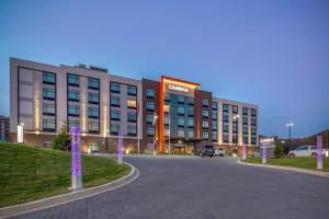 a large building with purple lights in front of it at Cambria Hotel Pigeon Forge in Pigeon Forge