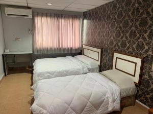 a hotel room with two beds and a window at Shakim hotel in Cukai