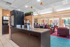a lobby with a bar and a living room at MainStay Suites Appleton Airport - Fox River Mall Area in Appleton