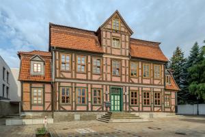 a large house with a green door in front at ipartment Wolfsburg HOME by Best Western in Wolfsburg