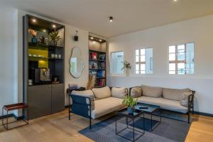 a living room with a couch and a table at ipartment Wolfsburg HOME by Best Western in Wolfsburg