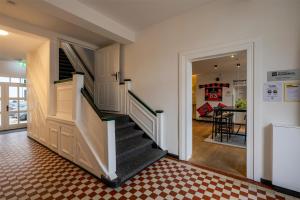 a hallway with a staircase in a house at ipartment Wolfsburg HOME by Best Western in Wolfsburg +51 photos