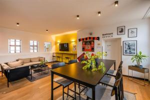 a dining room and living room with a table and chairs at ipartment Wolfsburg HOME by Best Western in Wolfsburg