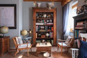 a living room with a book shelf with books at Alice Relais Nelle Vigne in Vittorio Veneto