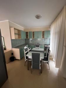 a kitchen and dining room with a table and chairs at Angel in Primorsko