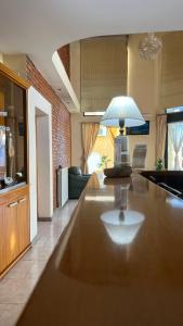 a living room with a table with a lamp on it at Manantiales Hotel Boutique in Victoria