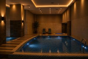 a swimming pool in a hotel room with a hotel at Whispers above the city 2Bhk Centaurus Mall pool Gym City view in Islamabad