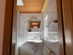 a bathroom with a sink and a mirror at Pension Embacher GmbH & Co KG in Viehhofen +95 photos