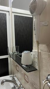 a hair dryer sitting on a counter next to a sink at Manantiales Hotel Boutique in Victoria +24 photos