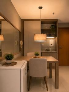 a dining room with a table and a chair at Comfortable Serviced Apartment by the Lake in Brasília