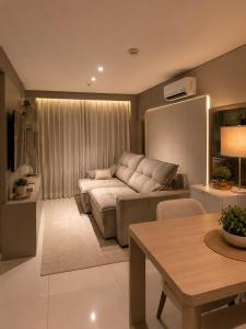 a living room with a couch and a table at Comfortable Serviced Apartment by the Lake in Brasília