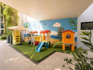 a childrens play area with a mural of a playground at Pool View 1 BR Apt for 3 - Diamond Condo 5209 in Bang Tao Beach