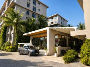 a car parked in front of a building at Pool View 1 BR Apt for 3 - Diamond Condo 5209 in Bang Tao Beach