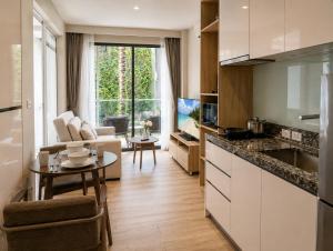 a kitchen and living room with a couch and a table at Pool View 1 BR Apt for 3 - Diamond Condo 5209 in Bang Tao Beach