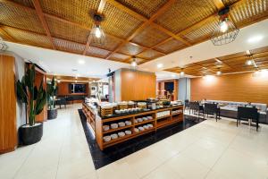 a restaurant with tables and chairs and a buffet at ASTON Pluit Hotel & Residence in Jakarta +92 photos