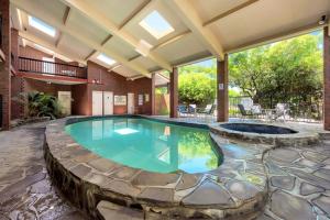 a large swimming pool in a house with a patio at Comfort Inn & Suites Sombrero in Adelaide