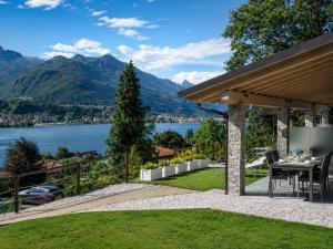a patio with a view of a lake and mountains at Residence Belvedere by Lago Reisen in Omegna