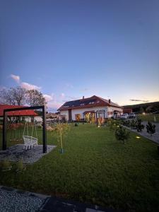 a yard with a playground and a house at Agroturystyka Myślinów - Black Horse Bar&Grill in Męcinka
