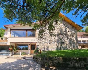a building with the entrance to a library at Le Vernay en Savoie - Petit Hôtel Nature in Saint-Maurice-de-Rotherens
