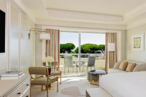a living room with a couch and a table at Rome Cavalieri, A Waldorf Astoria Hotel in Rome